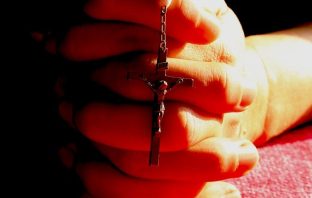 Hands with rosary beads