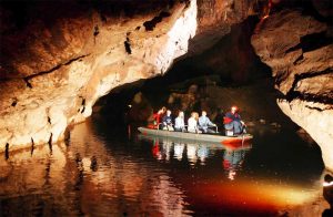 people on a boat in a cave